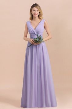 a woman in a long purple dress holding a flower