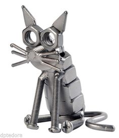 a cat made out of metal parts sitting on top of a white floor next to screws