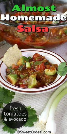 a bowl of salsa with tortilla chips and avocado on the side