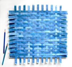 a piece of blue paper that has been made into a weaving pattern with two pencils