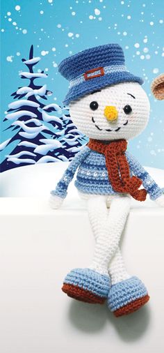 a crocheted snowman with a hat and scarf