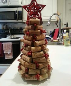 a christmas tree made out of wine corks in the middle of a kitchen counter