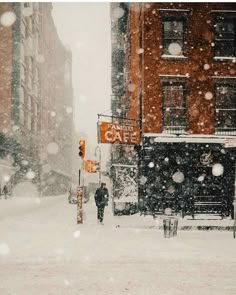 a man walking down a snow covered street