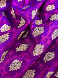 Gorgeous Banarasi Tanchoi Silk Saree. Handpicked from weavers of Banaras. Its a beautiful Half and half saree with Tanchoi and Buttis work on the half of the saree and the other half is just the tanchoi work. Item : Saree Color : Purple with Red with Muted Gold Zari Weave  Base Fabric : Banarasi Tanchoi Silk Blouse piece : Yes Blouse material : Banarasi Silk Work : Handwoven, handloom, zari woven, Handmade Fall & Edging(Pico) Yes/No : Yes Disclaimer -: - Color variation is possible due to variou Navratri Purple Brocade Traditional Wear, Purple Brocade Traditional Wear For Navratri, Brocade Handloom Saree For Puja, Handloom Brocade Saree For Puja, Brocade Saree With Traditional Patterns For Puja, Diwali Brocade Handloom Saree, Diwali Handloom Brocade Saree, Festive Brocade Traditional Wear With Pallu, Festive Brocade Saree With Self Design