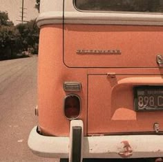 an orange truck is parked on the side of the road with it's license plate