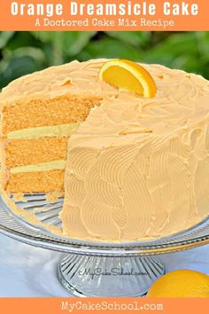 a cake with orange icing and a slice taken out of it on a plate