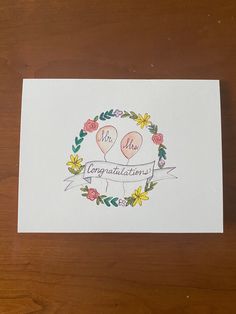 a card with two balloons and flowers on it that reads, mr and mrs congratulations