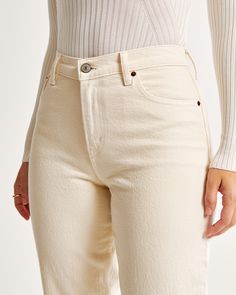 Our Curve Love 90's-style jeans in a neutral bone wash with a clean hem. This fit features a 9.5” mid rise, is fitted at the waist and hips, and eases at the thigh into a straight, full-length leg shape. Our Curve Love styles add an additional 2” at the hip and thigh to allow room for your curves and eliminate waist gap. This jean is made from our vintage stretch fabric which features both an authentic vintage look and contains slight built-in stretch for additional comfort. Casual Cream Cotton Flare Jeans, Casual Cream Cropped Leg Jeans, Casual Cream Cropped Jeans, Cream Straight Leg Jeans For Fall, Cream Pants With Five Pockets For Fall, Spring Cream Cotton Flare Jeans, Classic Tapered Leg Bottoms With Frayed Hem, Fitted Cream Jeans With Five Pockets, Fitted Cream Jeans