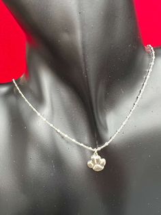 Sterling Silver or 14kt Gold Filled Necklace with Paw CharmSterling Silver 1.2mm Square Beads Link Chainor 14kt Gold Filled 0.6mm Satellite ChainPaw Charm - 10.75mm x 11.50mm (hollow back)Length - 15" with a 3" extender (Total Length 18")** If you need a different size please contact us** Chains are cut to size and are non refundable ** Dainty White Gold Round Beads Jewelry, Dainty Silver Pendant Chain, Sterling Silver Charm Necklaces With Round Beads, Sterling Silver White Gold Jewelry With Satellite Chain, Silver Satellite Chain Jewelry For Anniversary, White Gold Jewelry With Lobster Clasp As Gift, White Gold Sterling Silver Jewelry With Satellite Chain, Small Hypoallergenic Jewelry For Anniversary, Silver Charm Necklaces With Round Beads And Lobster Clasp