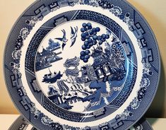 two blue and white plates sitting on top of each other