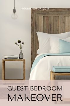 a bed with white and blue sheets in a bedroom next to a wooden headboard