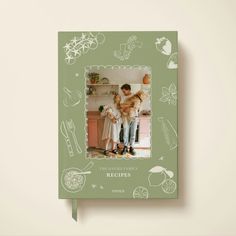 a book with an image of two children in the kitchen and on top of it