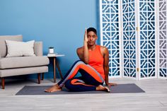 a woman sitting on the floor talking on her cell phone