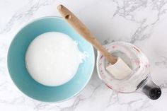 a bowl of yogurt next to a measuring cup