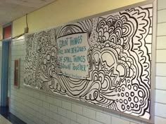 a mural on the side of a wall in a school hallway that reads great things