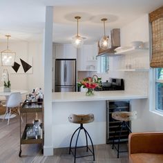 a kitchen with an island and bar stools