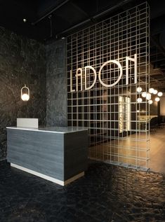 the reception desk is in front of an iron screen wall that says moon on it