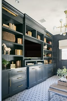 a living room with built in bookshelves and a television