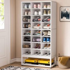 a white bookcase filled with lots of shoes next to a rug on the floor