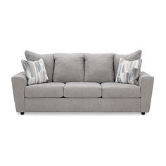 a gray couch with two pillows on it