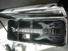 an electric guitar in a case on the floor