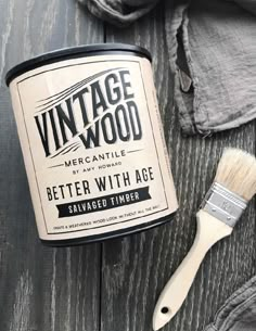 an old paint can with a brush next to it