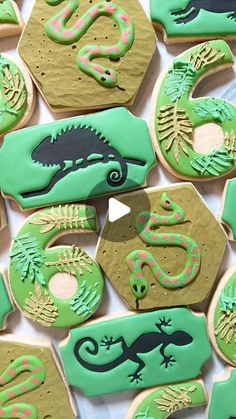 cookies decorated with green and black icing on a table