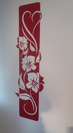 a red and white flowered design on the side of a wall in a room