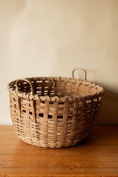 a wicker basket sitting on top of a wooden table