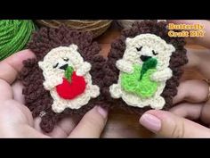 two crocheted animals are being held in their hands