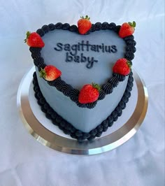 there is a heart shaped cake with strawberries on the top that says sagittrius baby