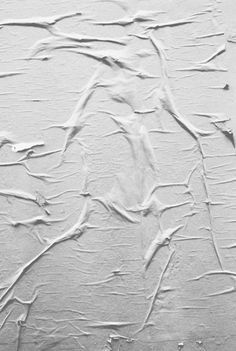 an abstract painting with white paint and lines on the wall, in black and white