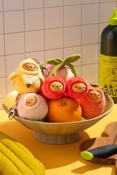 a bowl filled with fruit sitting on top of a counter