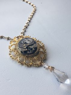 A lovely bright gold necklace. It comes with a high polished watch movement and a crystal. Timeless Gold Metal Pocket Watch, Timeless Gold Metal Necklace, Gold Metal Pocket Watch With Chain, Steampunk Necklace With Adjustable Metal Chain, Gold Steampunk Round Pendant Jewelry, Gold Steampunk Necklaces, Steampunk Metal Necklace With Adjustable Chain, Gold Steampunk Jewelry With Round Pendant, Steampunk Style Metal Necklace With Adjustable Chain