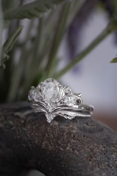 a diamond ring sitting on top of a rock