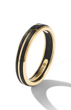 a black and gold wedding ring on a white background