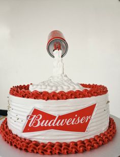 a white cake with red chains around it and a budweiser bottle on top