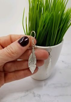 Now offering FREE SHIPPING on all US orders and 10% off all orders of $100 or more! Items ship in 1-3 days Two large, elegant sterling silver feathers float down the neck on sterling silver ear wires to make a simple yet stunning pair of earrings that can compliment an evening dress or dress up jeans and a tee. Earrings are about 2.25 inches long. All metal components of this item are 925 solid STERLING SILVER (NOT plated) Makes a great gift for a friend, sister, mom or yourself! -5-star satisfa Sterling Silver Earrings For Summer, Minimalist Sterling Silver Earrings For Summer, Sterling Silver Earrings For Everyday Summer Wear, Nickel Free Sterling Silver Summer Earrings, Adjustable Silver Earrings For Summer, Silver Jewelry For Everyday Summer Wear, Casual Silver Earrings For Summer, Silver Casual Summer Earrings, Casual Silver Summer Earrings