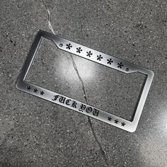 a metal license plate on the ground that says,'too soon'in black and white