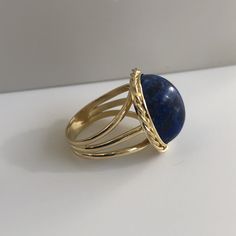 Lapis lazuli - richly blue and in excellent shape. This massive lapis is held in a beautiful vintage ring crafted in 18K yellow gold with beautiful braided bezel detail. The shank splits in three different bands tapering down to a single band at the bottom of 4.30mm This ring is currently a size 8.5 but can be sized down upon request. With any pre-owned/Vintage/Antique items, it is common to have some wear, As we inspect each piece of our jewelry, we make sure the wear and tear is acceptable wit Elegant Blue Oval Cabochon Signet Ring, Blue Cabochon Sapphire Ring In 14k Gold, Elegant Blue Gemstone Dome Ring, Classic Blue Lapis Lazuli Rings, Blue 14k Gold Oval Cabochon Rings, 14k Gold Blue Oval Cabochon Rings, Elegant Lapis Lazuli Ring Jewelry, Oval Blue Lapis Lazuli Rings, Elegant Blue Gemstone Signet Ring