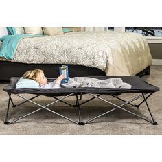 The Regalo Gray Extra Long My Cot Portable Toddler Bed is a multi-functional cot for your little one who needs a safe, comfortable place to rest.An essential item for travel, sleepovers, nap time, picnics, and camping, the My Cot was designed for portability. The extra-long My Cot comes in at 54” long and can hold children up to 75 pounds, making it ideal for children 2-5 years old. Made of an all-steel construction, the versatile cot is built with durability, safety, and convenience in mind. Sturdy canvas material lines the cot while a fitted sheet is included for added comfort while your little one rests or playsMeasurements: 7 Height/Inches, 26 Width/Inches, 54 Length/InchesAssembly: Ready-To-AssembleBase Material: 50% Metal, 50% CanvasFabric Description: CanvasCare: Machine Washable C Portable Toddler Bed, Toddler Wardrobe, Toddler Cot, Cozy Bedroom Design, Portable Bed, Camping Cot, Kids Camping, Toddler Beds, Crib Toddler Bed