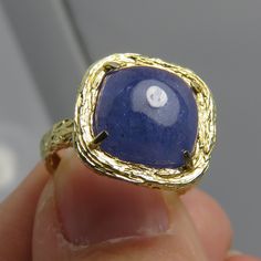 Estate very nice 14k size 5 large cushion cut cabochon purple tanzanite stone 9.54mm. 3.5 grams. beautiful detail work on ring. marked 14k. by pz isral. Unique Yellow Gold Sapphire Ring For Anniversary, Unique Yellow Gold Sapphire Ring For Formal Occasions, Heirloom Tanzanite Yellow Gold Rings, Heirloom Tanzanite Rings In Yellow Gold, Luxury 14k Stamped Sapphire Ring Gift, Yellow Gold Tanzanite Rings, Yellow Gold Tanzanite Ring With Polished Finish, Luxury Gift Sapphire Ring Stamped 14k, Gold Tanzanite Round Rings