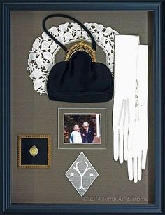 a black purse, white gloves and other items are on display in a shadow box