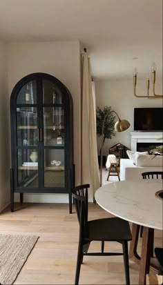 a dining room table with chairs and a tv