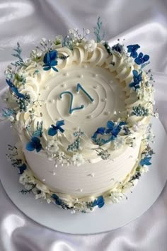 there is a white cake with blue flowers on it