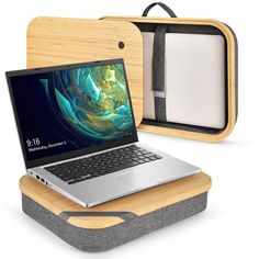 an open laptop computer sitting on top of a wooden box