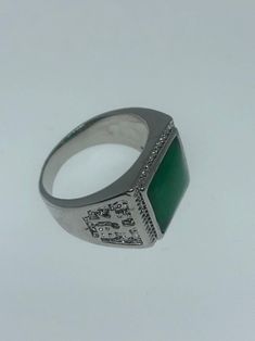 Large green nephrite jade Ornate German Silver Vintage ring, does not tarnish, NOT sterling Has Chinese lettering for luck on the sides. Sizes 8, 9 10 or 11 All rings are shipped in a nice gift box. Check out our over a THOUSAND great reviews Engraving is $4 per letter and is not always perfect depending on the piece. It can take a few days if the jeweler is busy. This is payable to Paypal Judithsltd@gmail.com Green Rectangular Signet Ring For Formal Occasions, Green Signet Ring With Polished Finish For May Birthstone, Classic Green Signet Ring Stamped 925, Symbolic Green Gemstone Jewelry, Green Emerald Cut Signet Ring With Polished Finish, Green Emerald-cut Signet Ring With Polished Finish, Green Oval Engraved Rings, Formal Green Engraved Signet Ring, Hallmarked Green Rectangular Rings