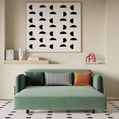 a living room with a green couch and black and white artwork