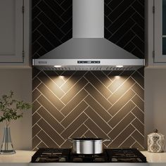 a stove top oven sitting inside of a kitchen next to a vase with flowers on it