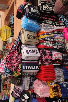 there are many different items on display in this market place, including t - shirts and hats